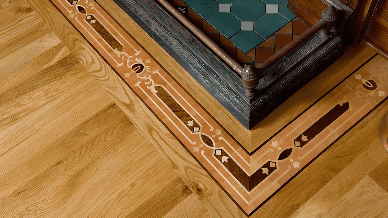 Intricate decorative hardwood floor border and corner inlay handcrafted in the USA. Premium wood flooring design for framing rooms and islands by Czar Floors.