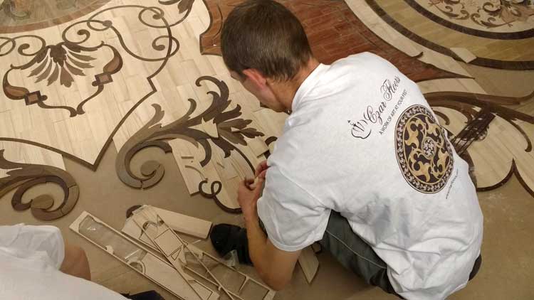 Custom whole room intricate wood rug inlay assembly - fitting the elements