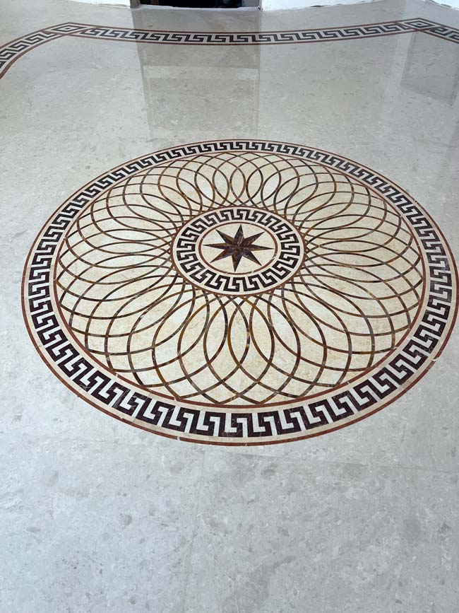 686: 10-foot custom marble medallion. Notice the seams are practically invisible with the precise cutting of solid stone elements. The floors are polished to create a single-slab appearance.