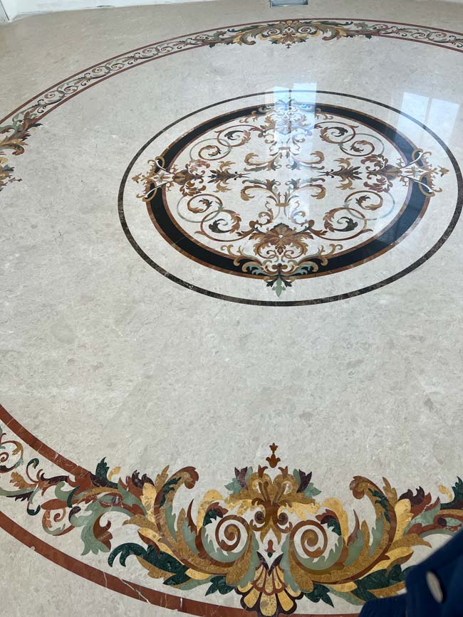 685: A custom curved border surrounds Rafael medallion. Solid stone.