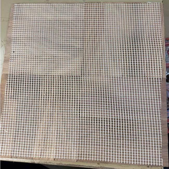 678: Back side of 5/16 thcik fingerblock module with mesh net backing. This side is glued to the subfloor.