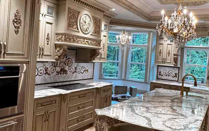 Multiple marble inlay wall panels extend beyond cabinets. 