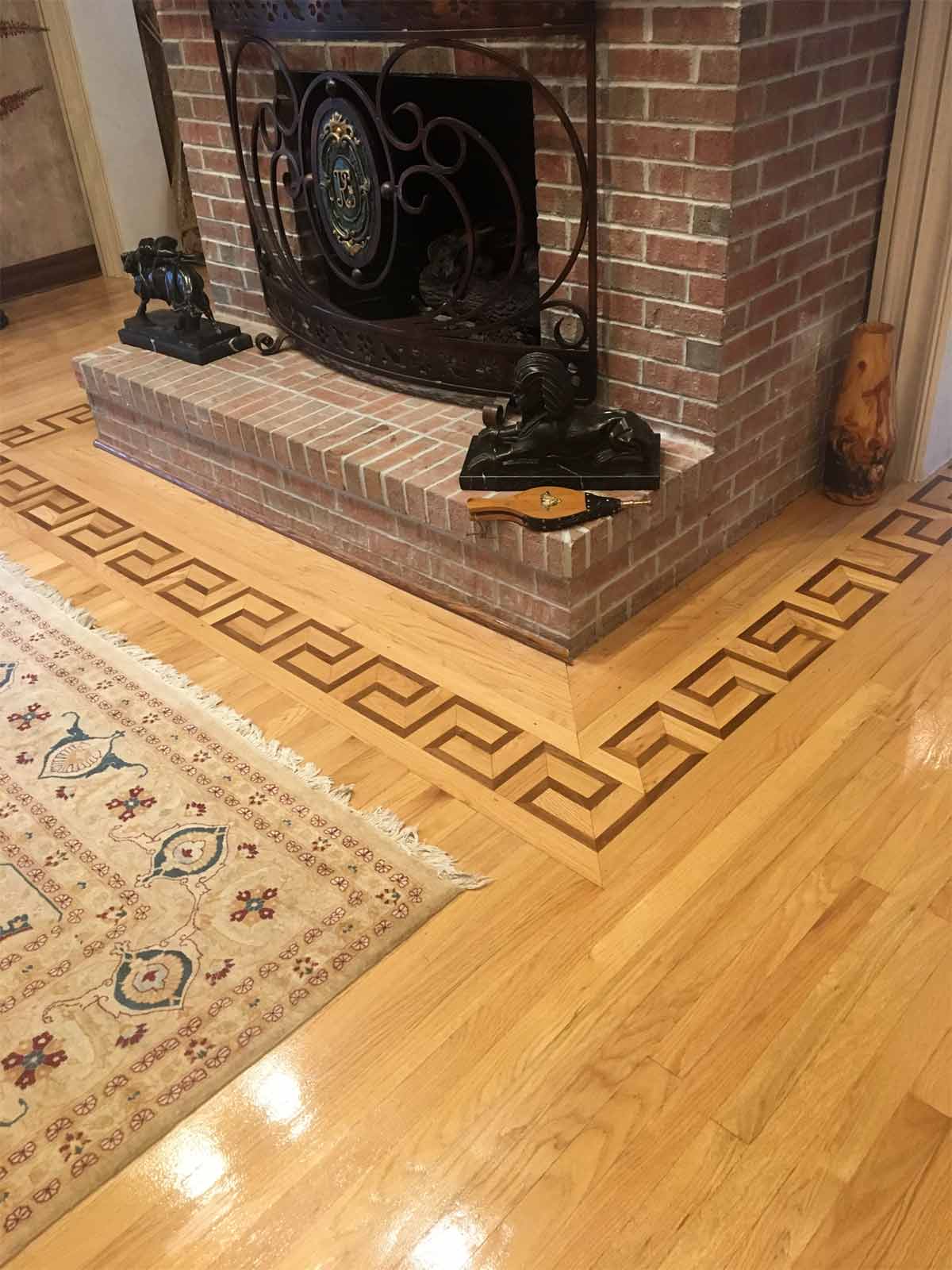 576: Classic Greek Key wood border around the fireplace.