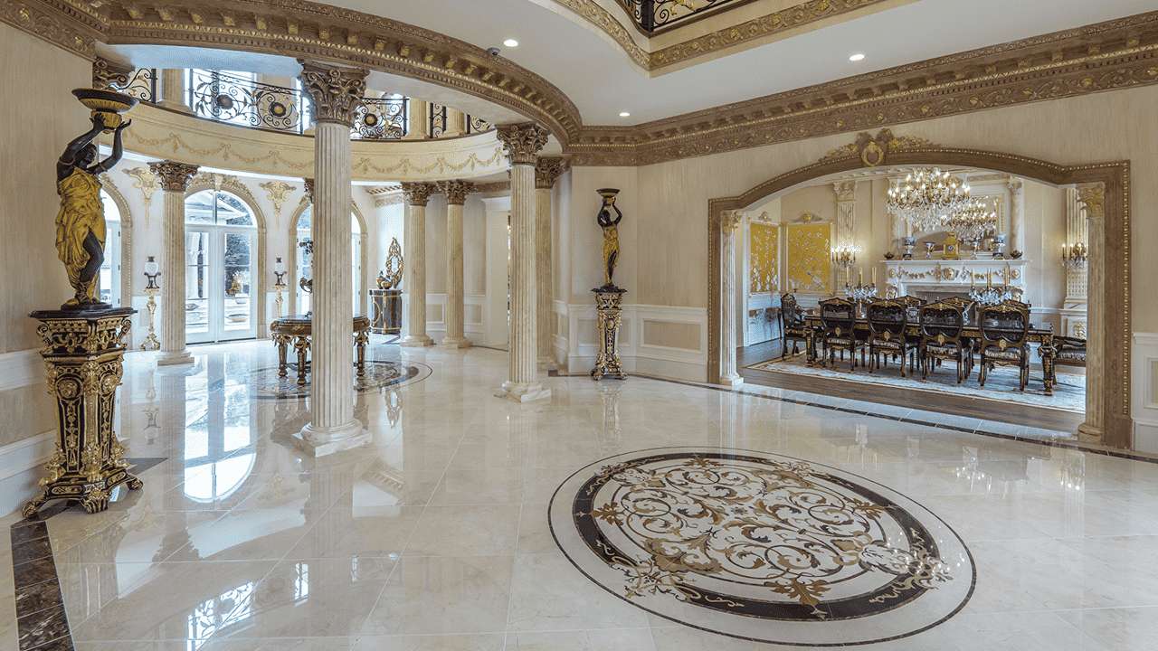 Large custom waterjet marble floor medallion in a luxury ballroom foyer. Precision-cut stone inlays handcrafted in the USA by Czar Floors.